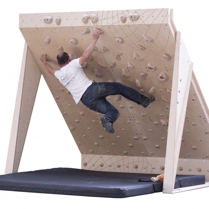 home bouldering wall 40 board 8ft wide with wooden climbing holds and man climbing problem